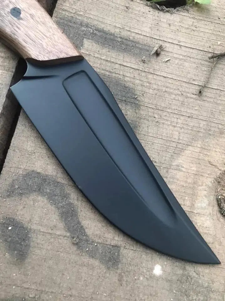 Black coated blade close-up on walnut handle knife