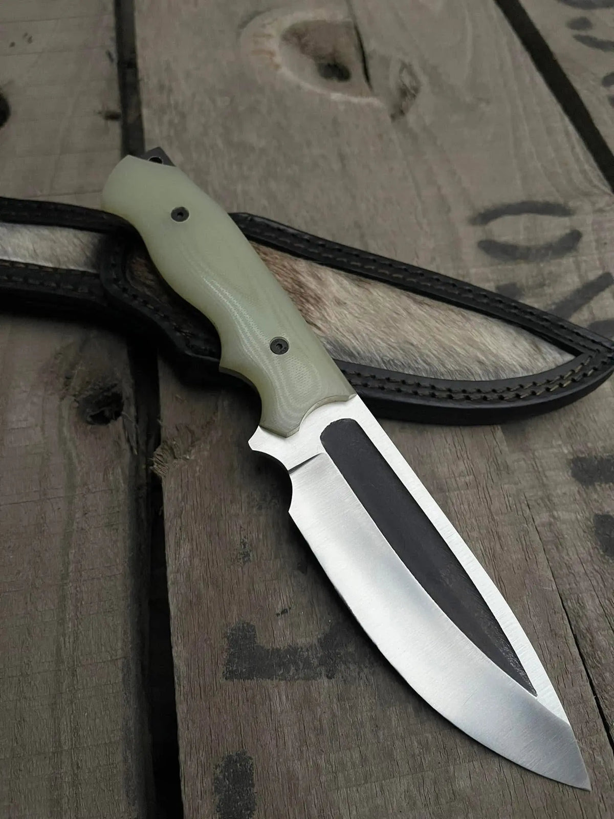 Satin polished D2 steel blade with fuller close-up on cowboy knife