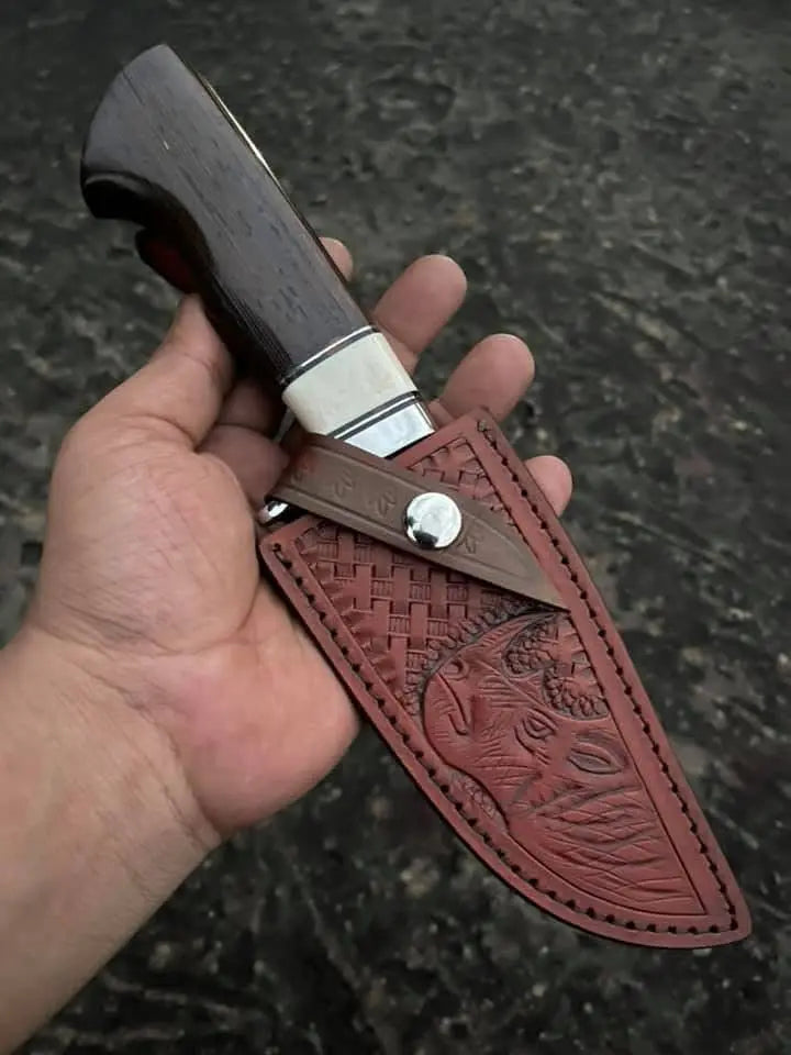 Satin polished D2 steel drop point blade with steel finger guard close-up