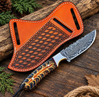 Damascus steel drop point blade close-up on cowboy knife with turquoise handle