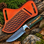 Damascus steel drop point blade close-up on cowboy knife with green handle