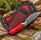 Damascus cowboy skinner knife on wood background - side angle