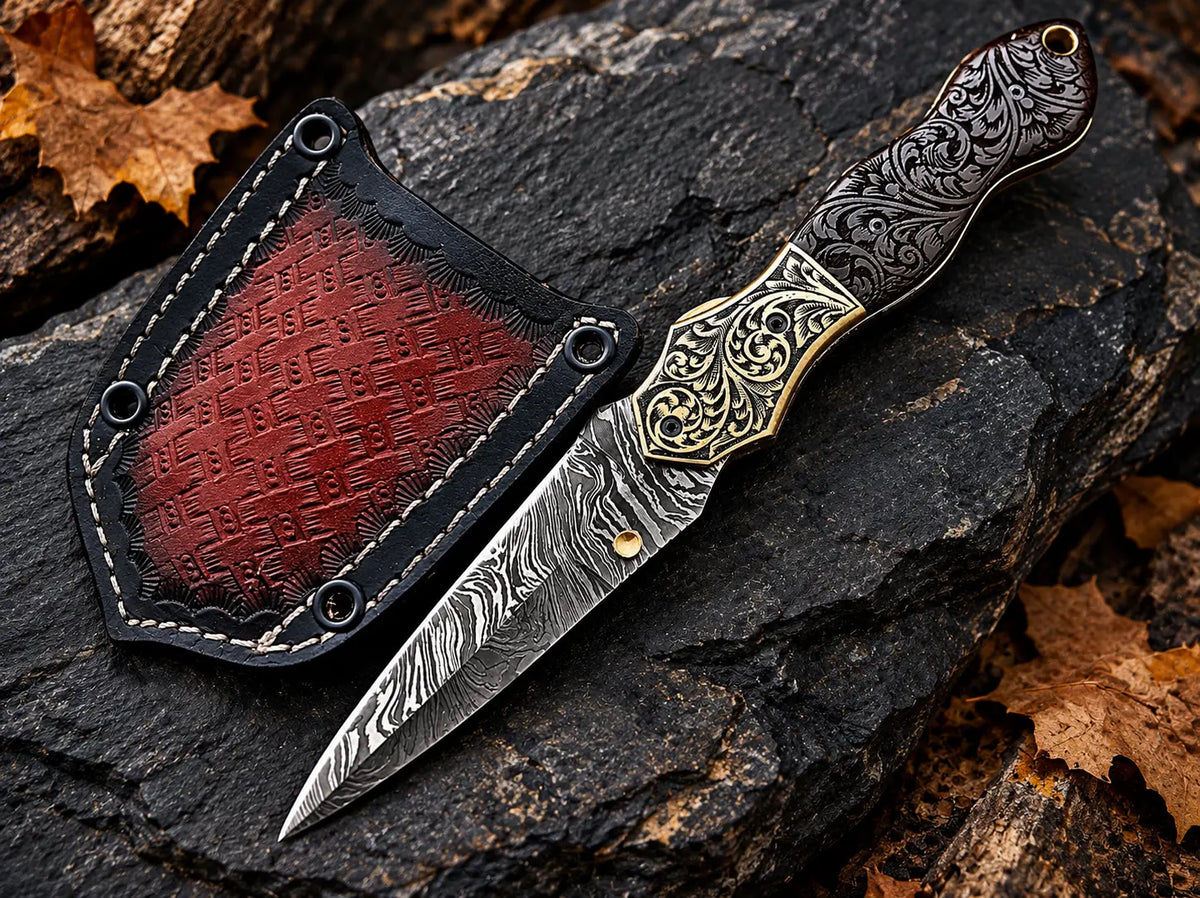 Handmade Damascus folding knife with hand-engraved brass bolsters, carved wood handle, brass thumb stud and red leather sheath - full view