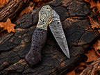 Handmade folding knife with carved wood scales and brass bolsters - angle 4