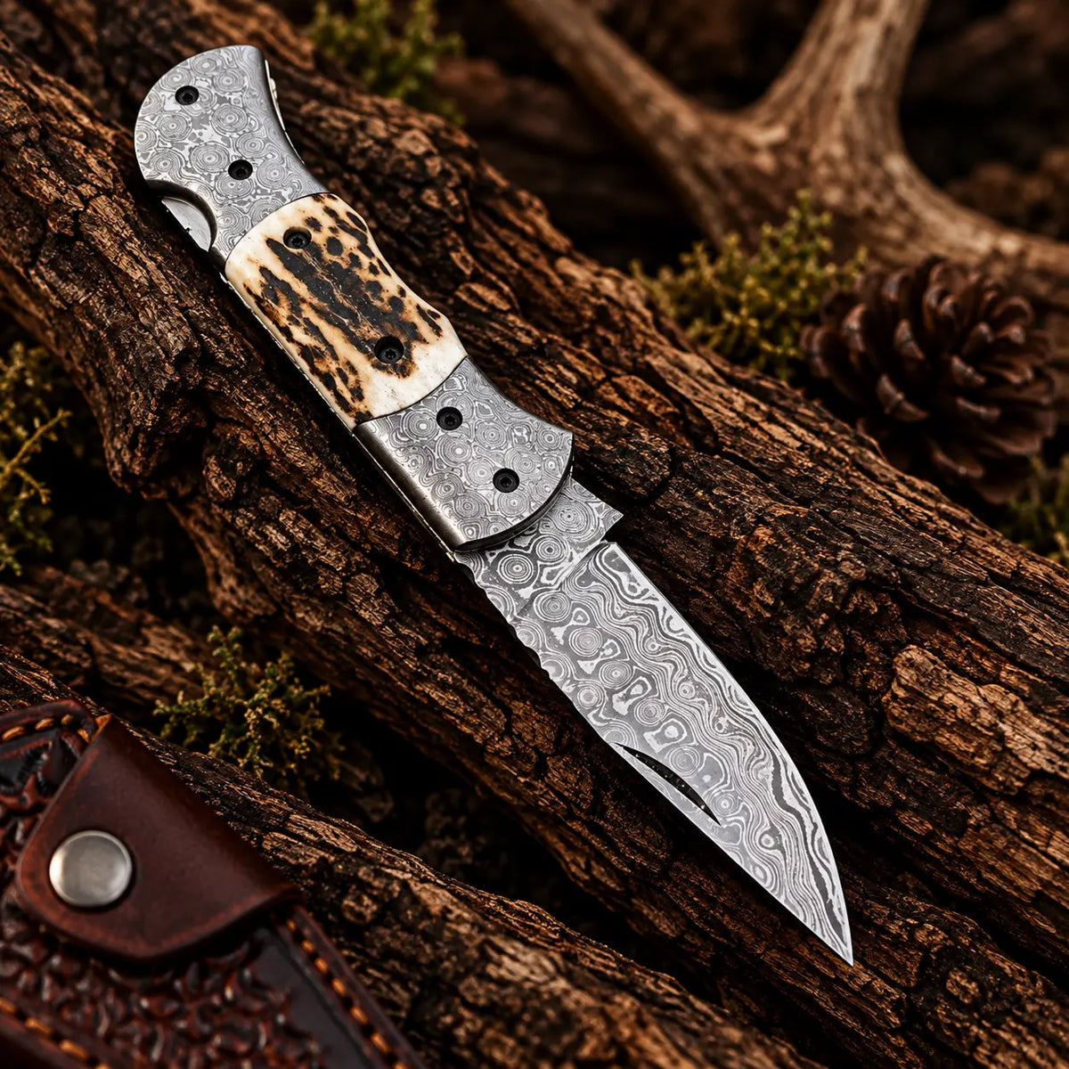Stag antler handle detail on Damascus folding knife