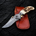 Handmade Damascus folding knife with stag horn handle, liner lock and Italian leather pouch - full view