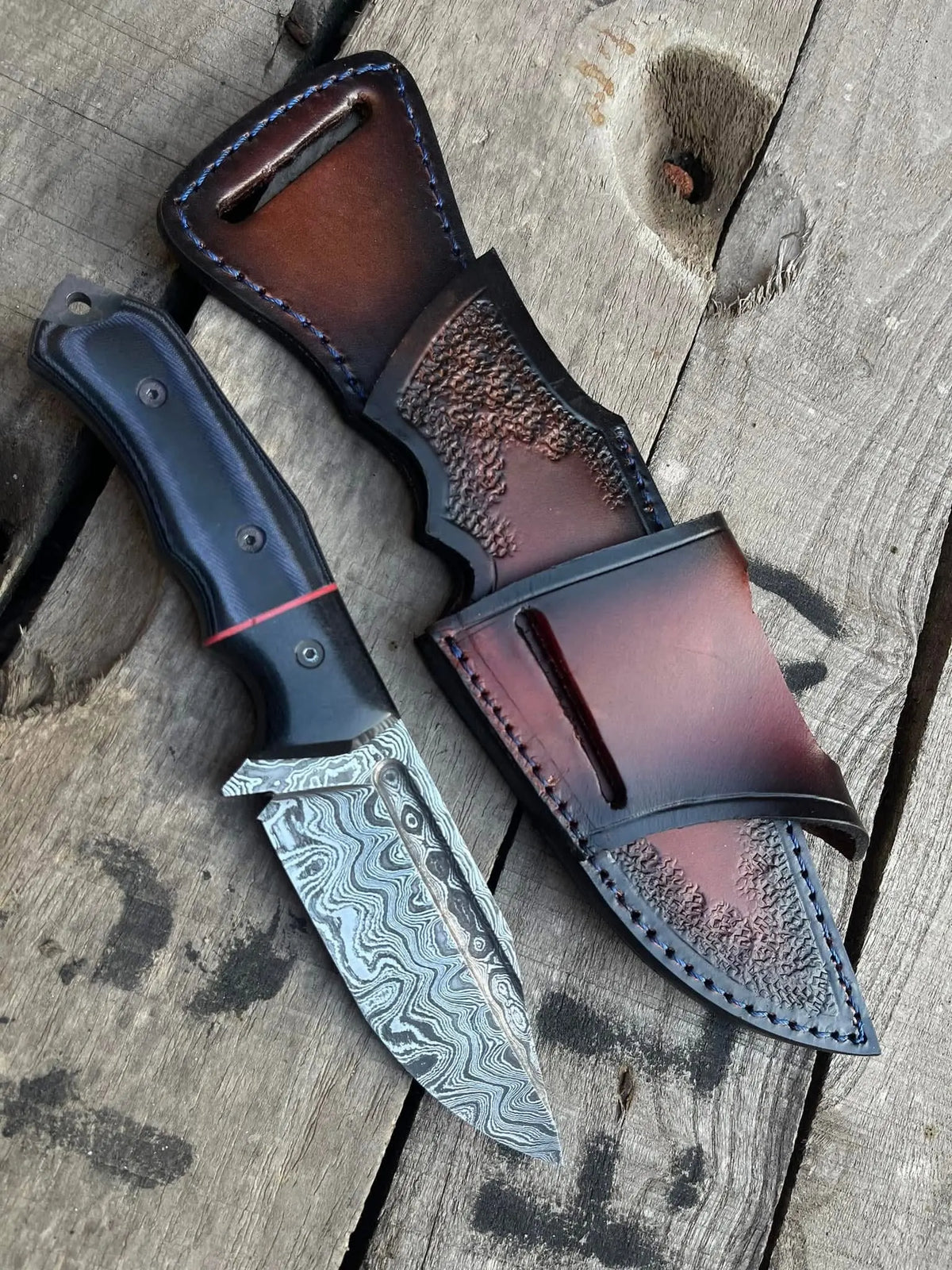 Handmade full tang Damascus skinner knife with blue and black micarta handle and leather sheath - full view