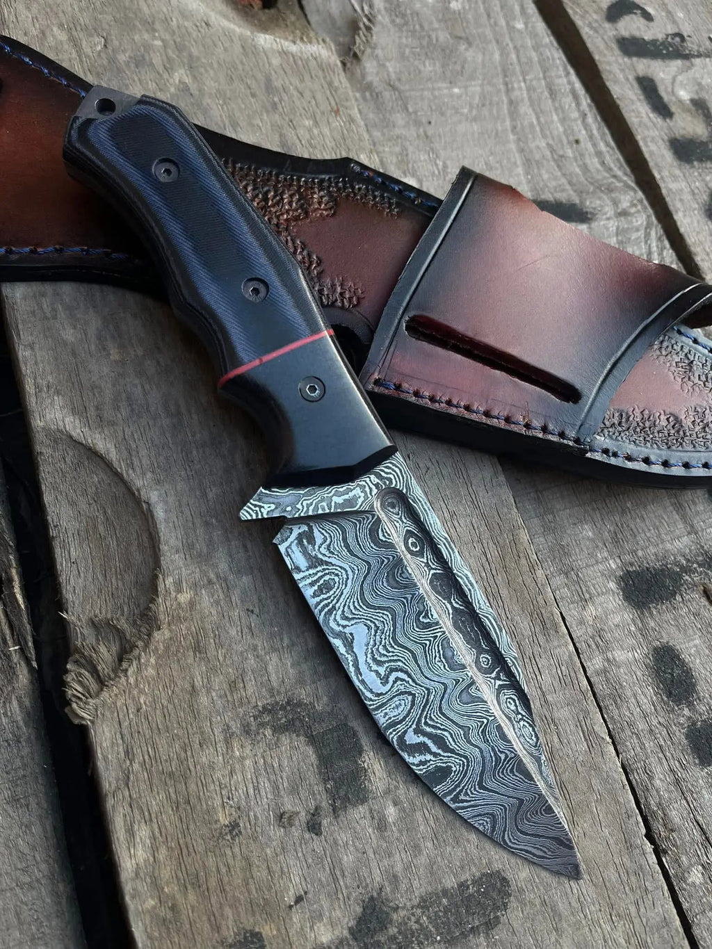 Damascus steel blade with fuller close-up on full tang skinner knife