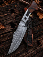 Rosewood handle with Damascus tang cutout detail on hunting knife
