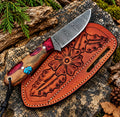 Handmade Damascus steel skinner knife with turquoise inlay handle and tooled leather sheath - full view