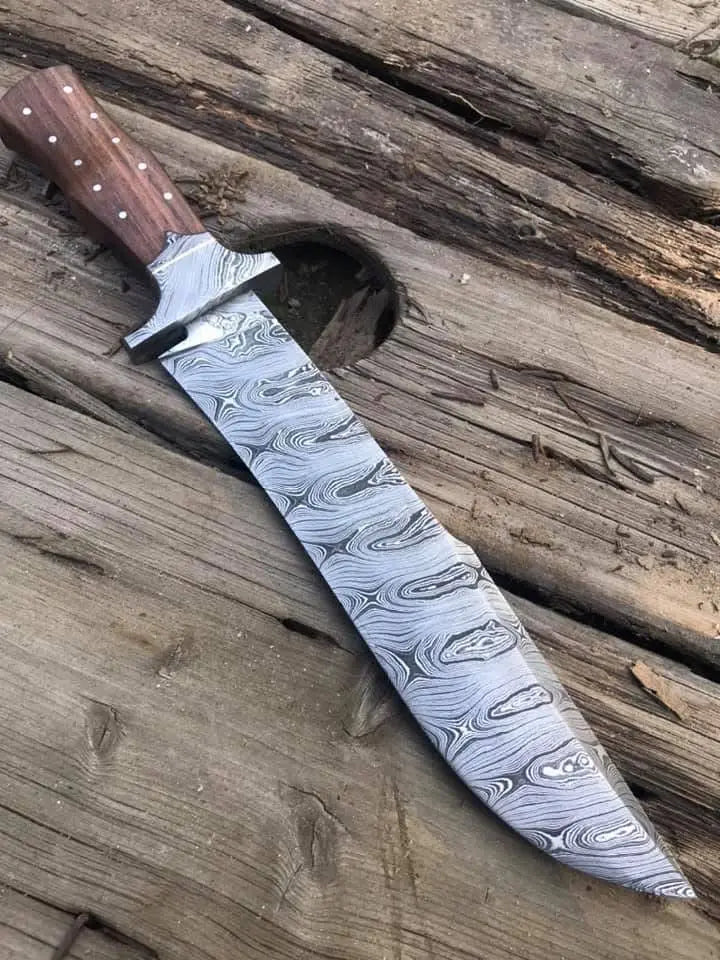 Damascus steel clip point blade pattern close-up on bowie knife