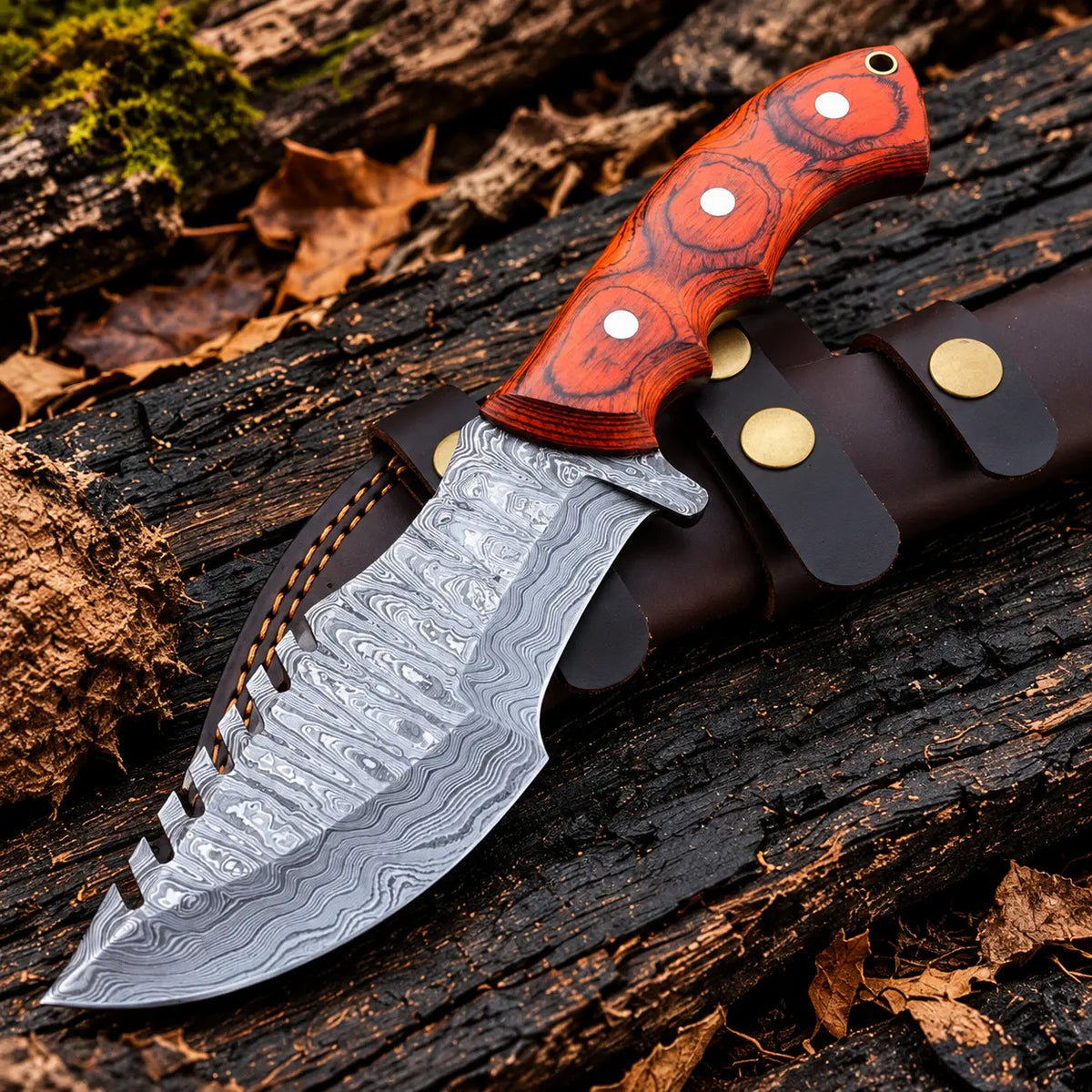 Handmade Damascus steel tracker knife with orange-red pakka wood handle, silver pins and horizontal leather sheath - full view
