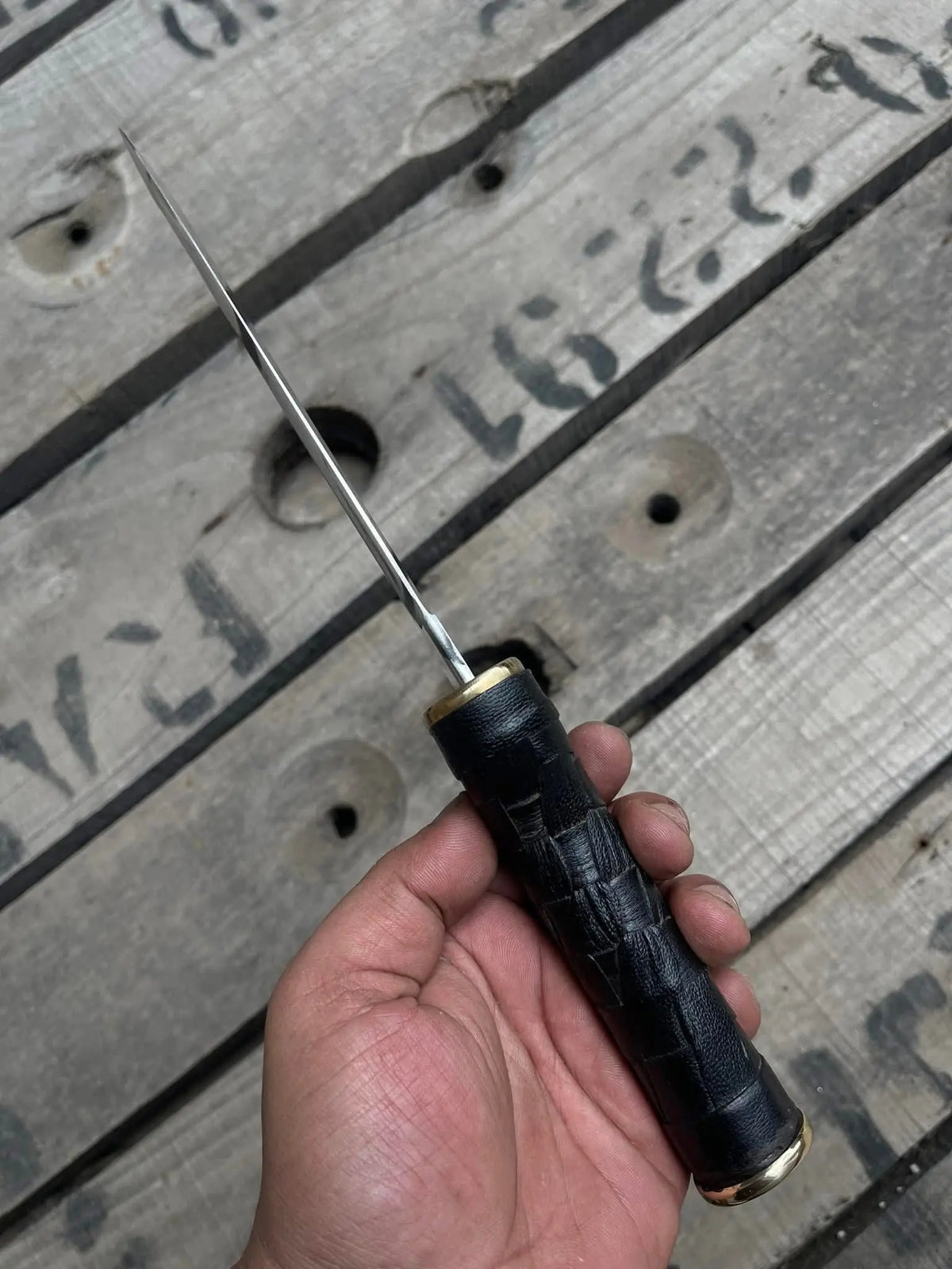 Black woven texture wrapped handle detail on dagger knife