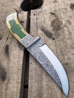Green stone and gold brass handle detail on engraved dagger