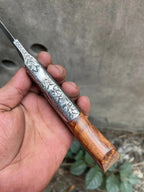 Floral engraving close-up on hand engraved fixed blade knife
