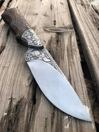 Scrollwork engraving close-up on blade ricasso of skinner knife