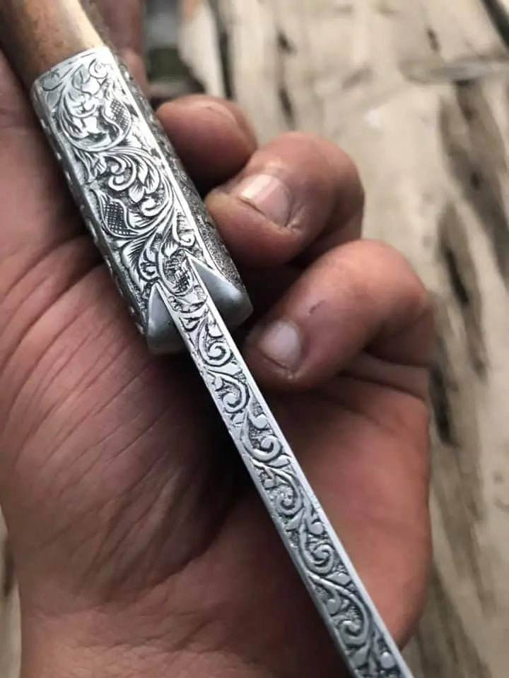 Hand engraved skinner knife on wood background - full length view