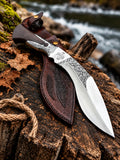 Handmade hand-forged carbon steel kukri knife with hand-engraved blade, Jerusalem cross, wenge wood handle and tooled leather sheath - full view