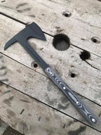 Handmade tomahawk axe on wood background
