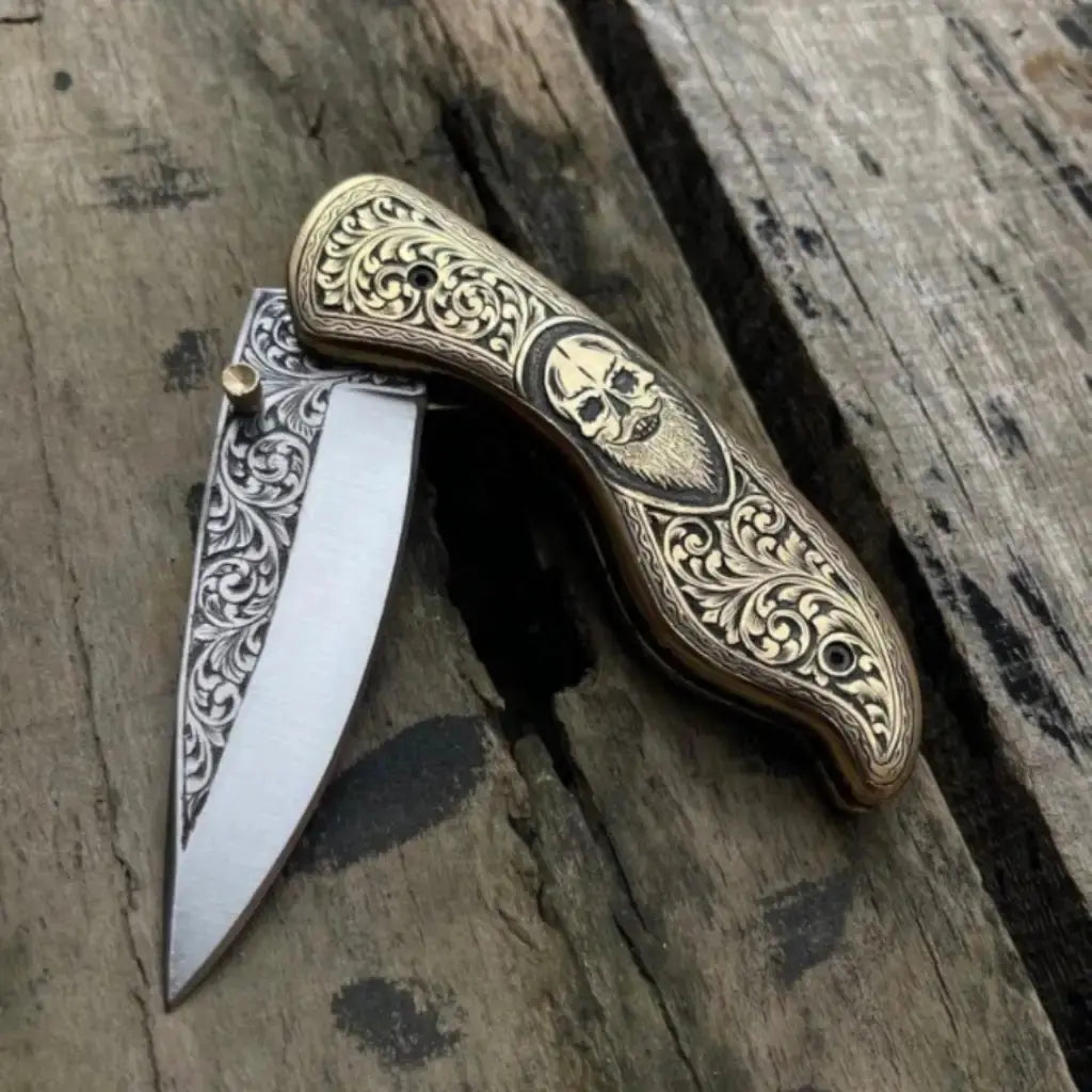 Skull design handle detail on gothic folding knife