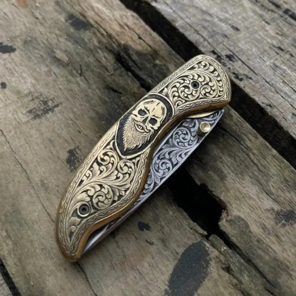 Gothic EDC folding knife with skull handle design detail
